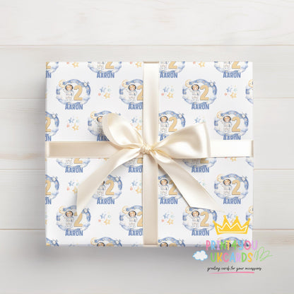 An additional close-up of the moon, stars and astronaut pattern printed on the wrapping paper