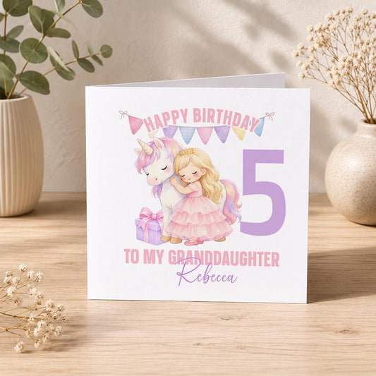 Square birthday card featuring a unicorn design with sparkles and wings, personalised with a girl's name, age and relation.