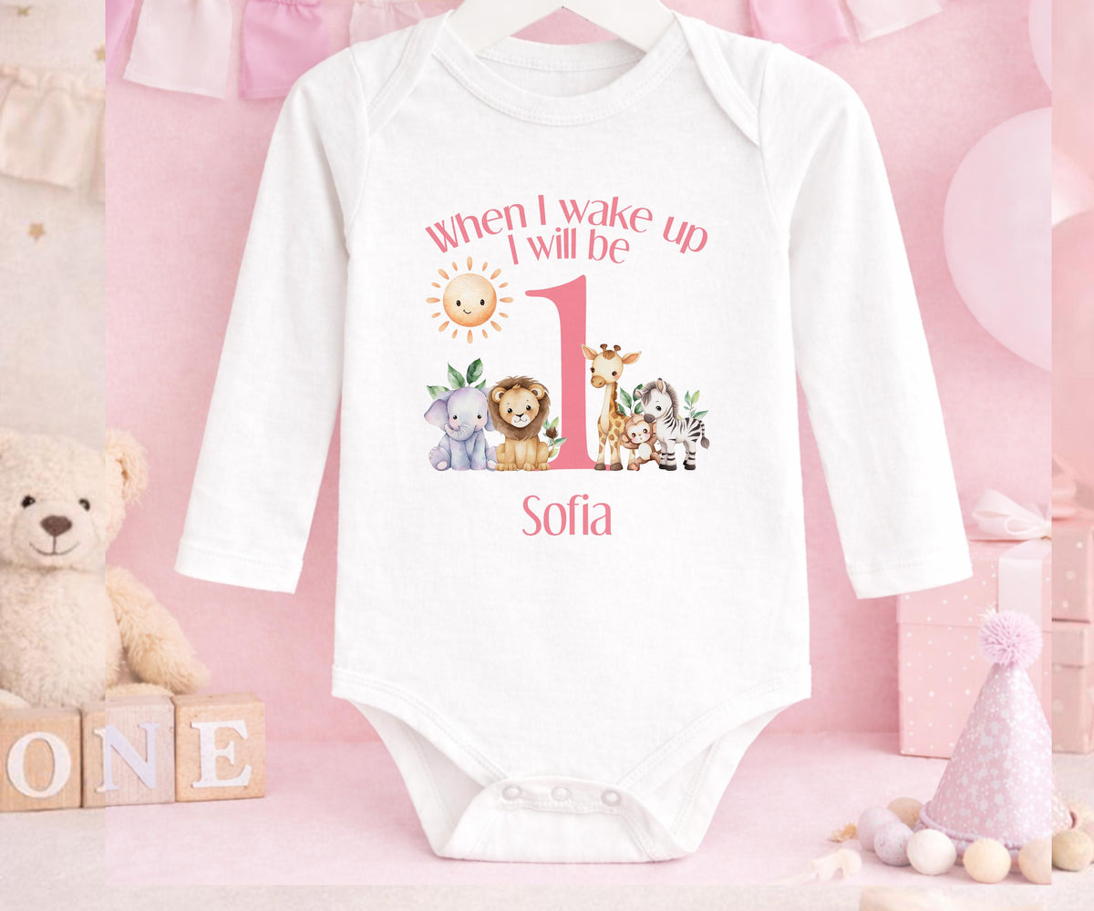 Personalised pink safari first birthday pyjamas with custom name and sunshine design.