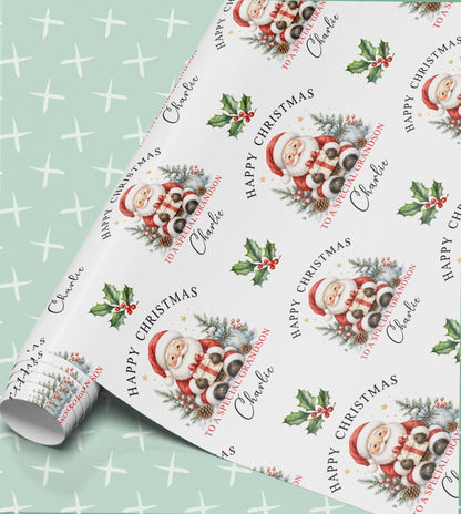 Personalised Christmas wrapping paper in mint green with Santa holding a present, holly and pinecones, Happy Christmas with a relation and name