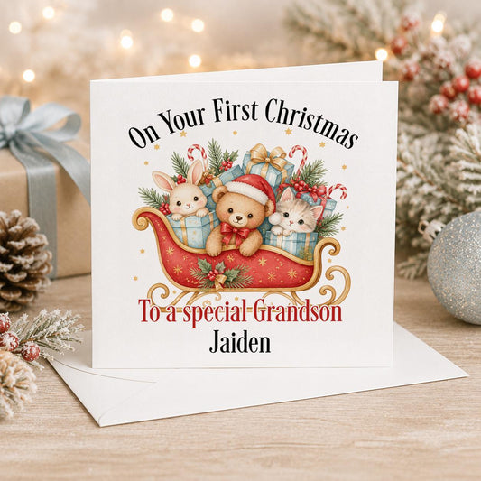 Personalised baby first Christmas card, white 6x6 inch square card printed with two animals in a red sleigh of presents and a name