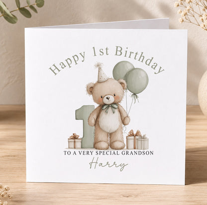 Personalised first birthday card featuring a teddy bear and balloons, printed with the recipient's name and relation