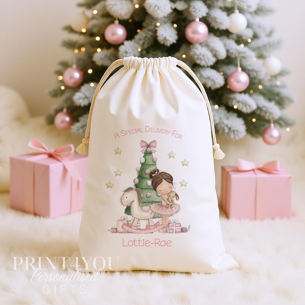 Personalised ballerina Christmas sack, cream cotton drawstring santa sack printed with a ballerina in a pink tutu beside a Christmas tree and a name
