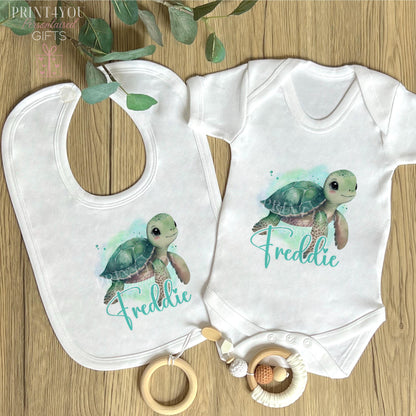 Close-up of the cute sea turtle print on the personalised newborn vest.