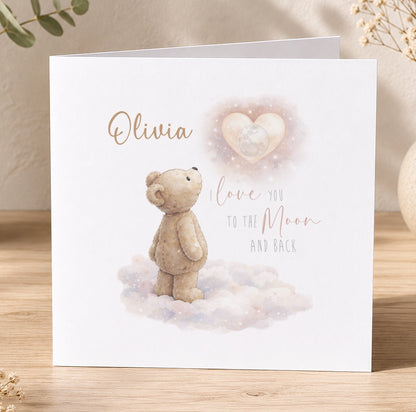Greeting card illustration of a teddy bear standing on clouds gazing up at the moon, with elegant script for a personalised message