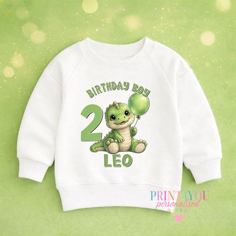 Personalised dinosaur birthday jumper for kids, printed with a custom name and age design on a cosy sweatshirt.