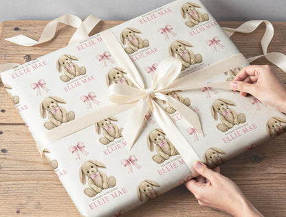 Sheet of personalised newborn bunny teddy wrapping paper folded to show the repeating pattern.