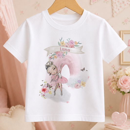 A white t-shirt with a printed design of a young girl in a pink tutu, surrounded by flowers and butterflies.