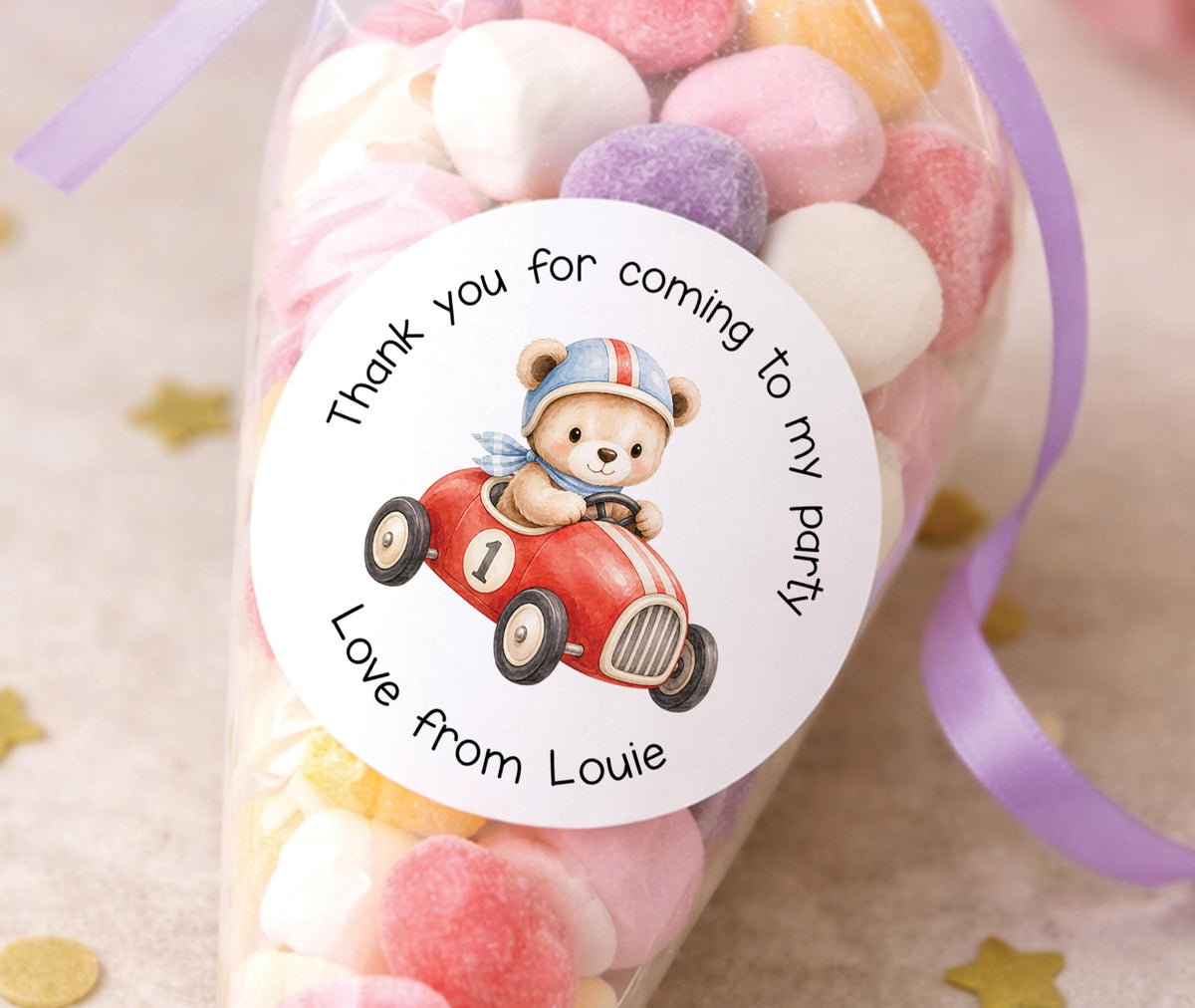 Personalised glossy round sticker featuring a teddy bear driving a racing car