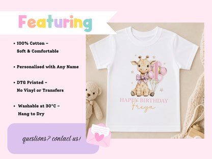 Personalised giraffe birthday t-shirt printed with 'Happy Birthday Freya', styled with a soft toy and a pink gift envelope.
