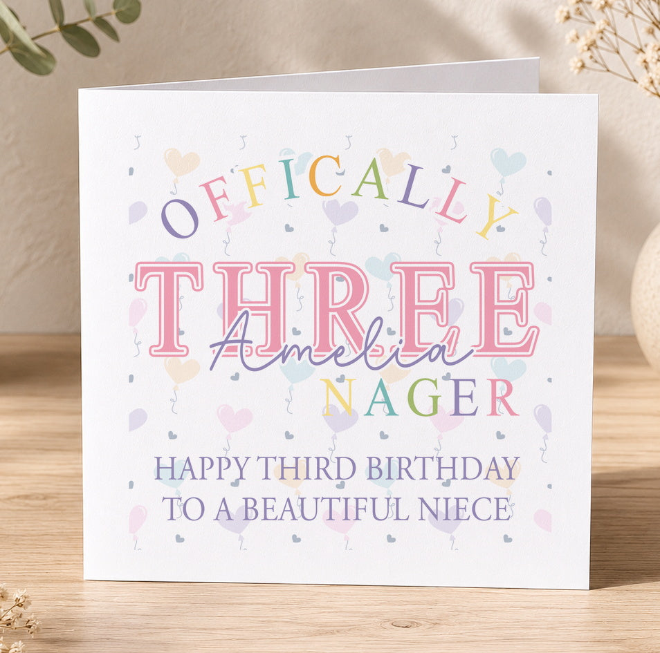 Personalised third birthday card featuring colourful Officially Three text and illustrations, shown with a personalisation example for a niece named Amelia