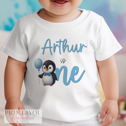 Personalised blue penguin first birthday vest with custom name printed on soft cotton