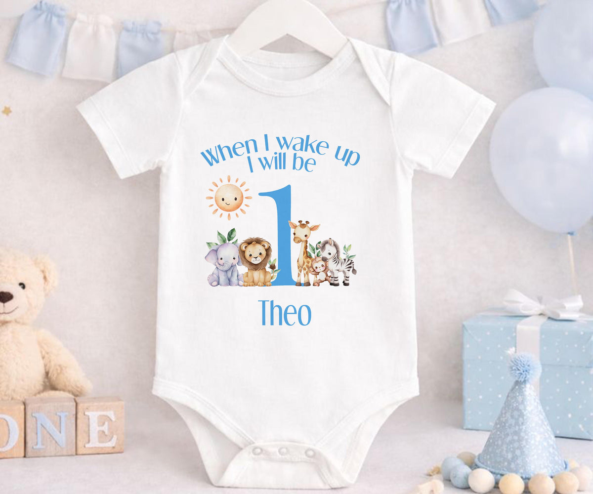 Personalised blue safari sleepsuit with custom name printed on soft cotton.