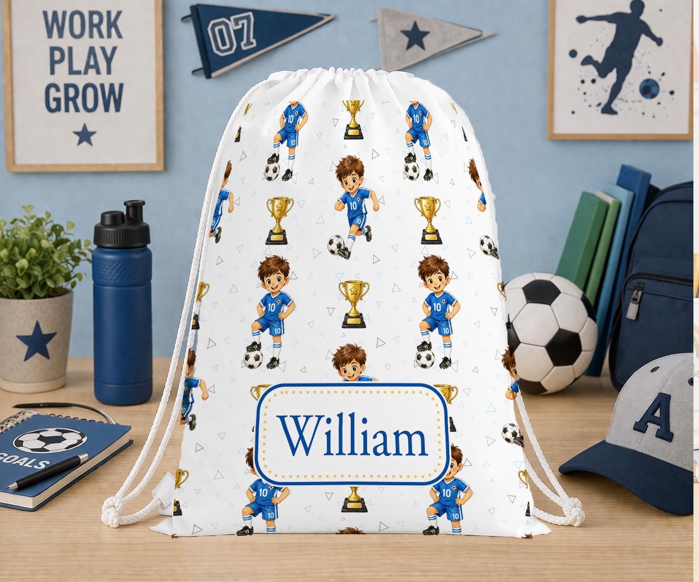 White drawstring PE bag printed with a football player, footballs and trophies in blue tones, personalised with the name William.