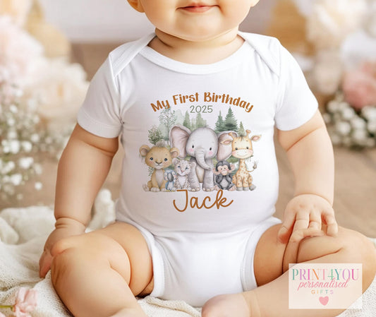 Personalised jungle safari 1st birthday bib, printed with baby's name and a lion, elephant and giraffe design.