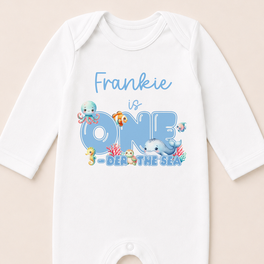 Personalised Ocean Friends first birthday onesie printed with your child's name and sea creature design.