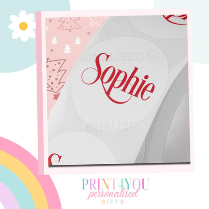 Close-up of personalised red festive Christmas name sticker with custom name printed on glossy label