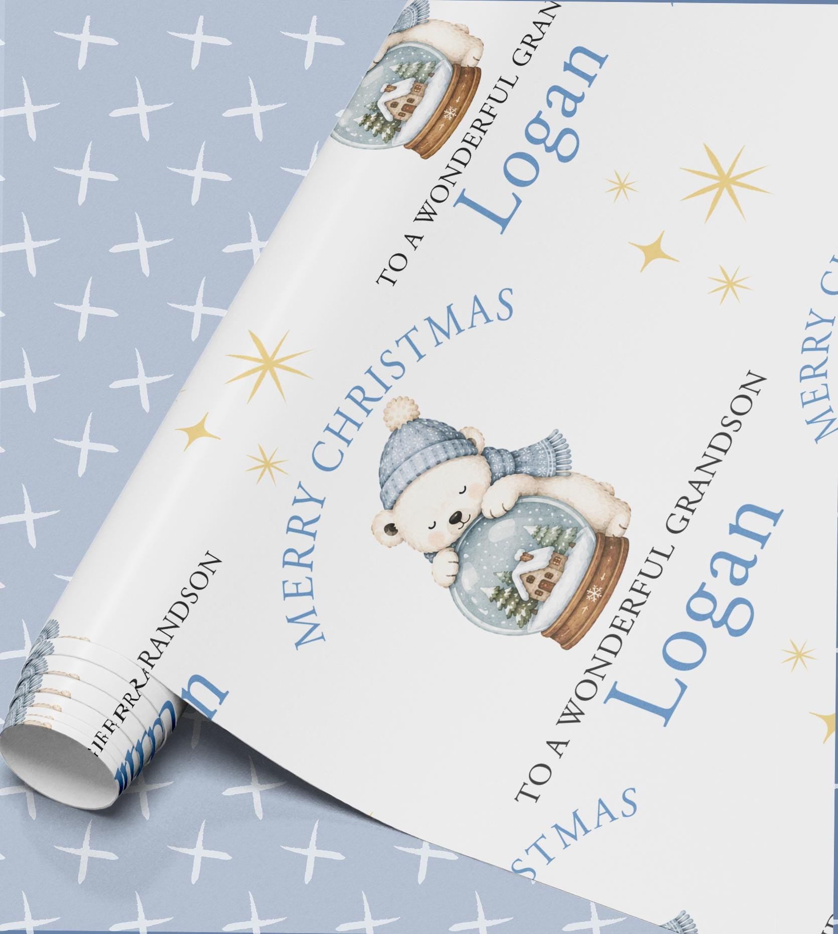 Roll of personalised polar bear snow globe Christmas wrapping paper shown posted in a sturdy postal tube.