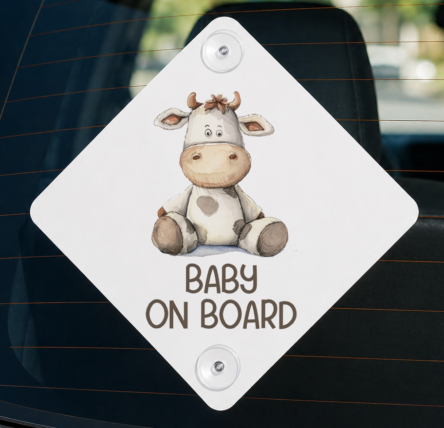 a sticker with a cartoon cow and the text "BABY ON BOARD" printed on it.