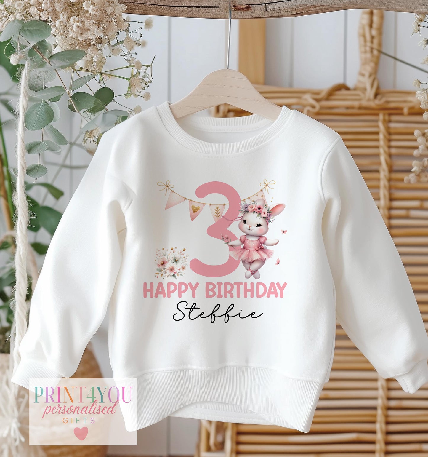 White cotton sweatshirt printed with a personalised ballerina bunny design, name and birthday number.