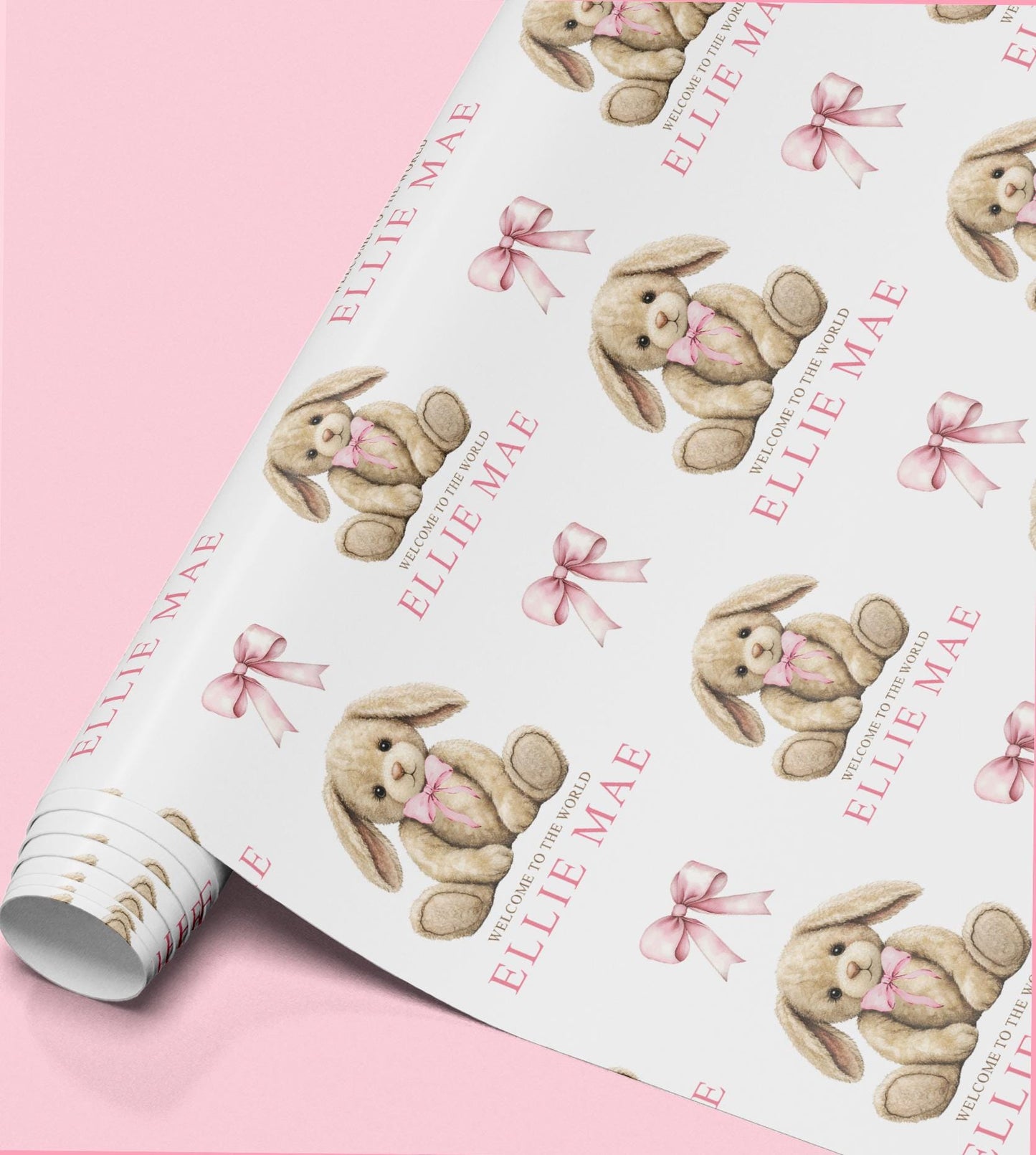 Roll of personalised newborn gift wrap with a repeating bunny teddy design in soft pink, personalised with the name 'Ellie Mae'.