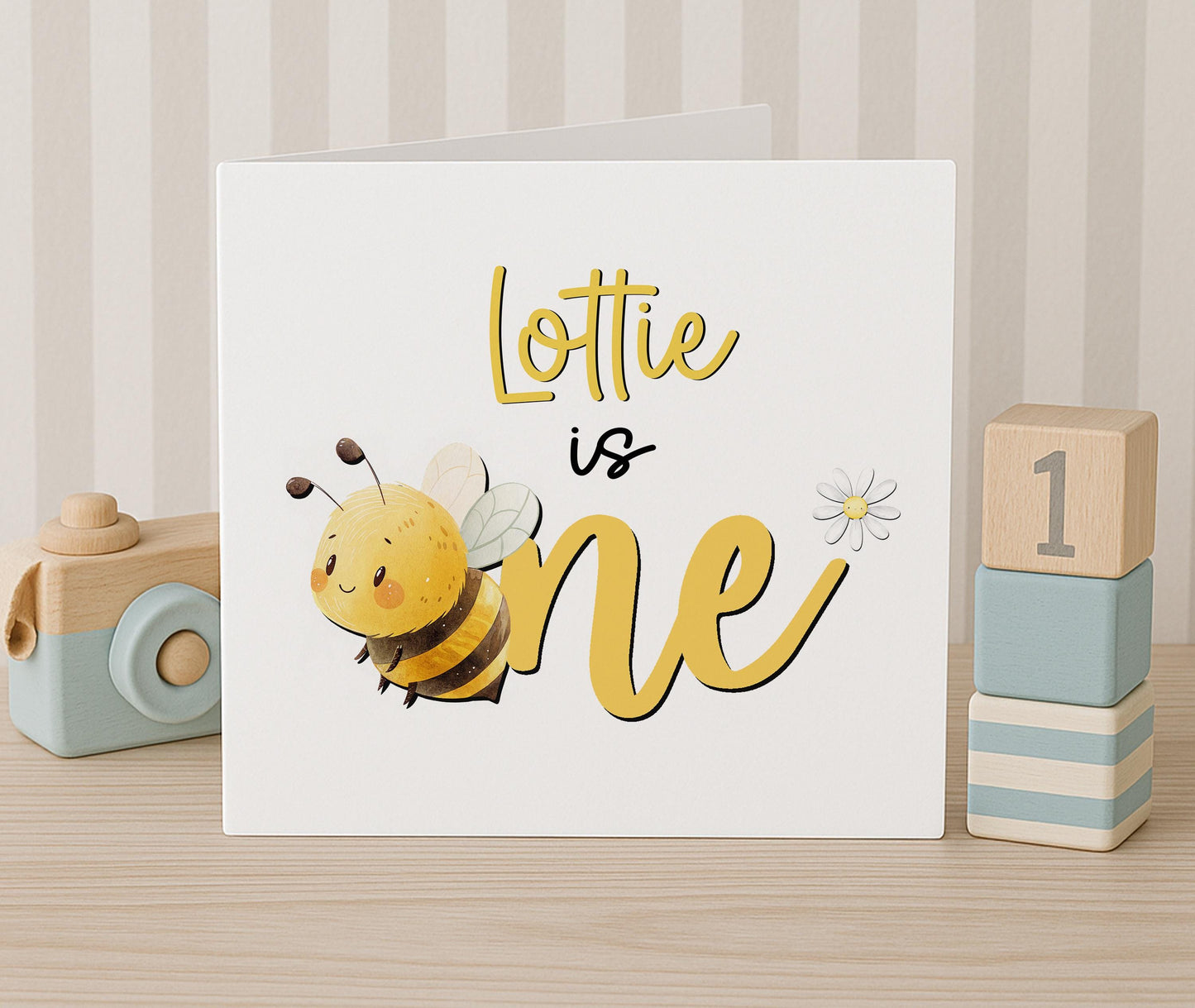 Personalised honey bee 1st birthday card, front view with white envelope