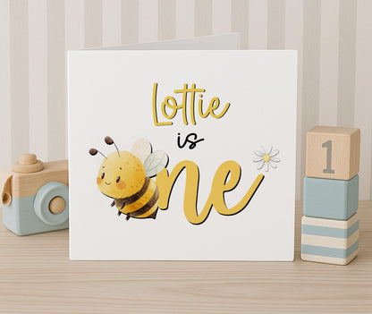 Personalised honey bee 1st birthday card, front view with white envelope