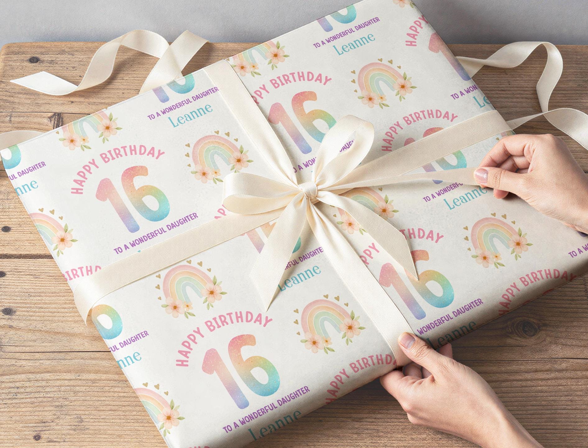Personalised rainbow wrapping paper sheet laid flat showing the full repeating pastel rainbow pattern.