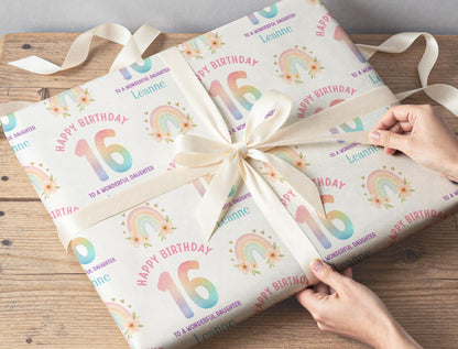 Personalised rainbow wrapping paper sheet laid flat showing the full repeating pastel rainbow pattern.