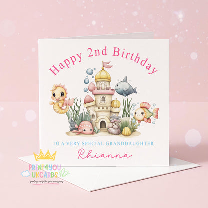 Front view of the personalised under the sea birthday card showing a pastel ocean castle scene with seahorses and fish.
