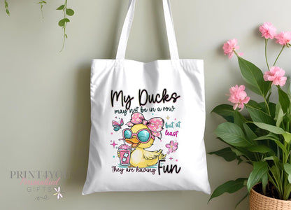 Personalised cotton canvas tote bag printed with a duck illustration and 'My Ducks Aren't In A Row' slogan, with custom name added below the design