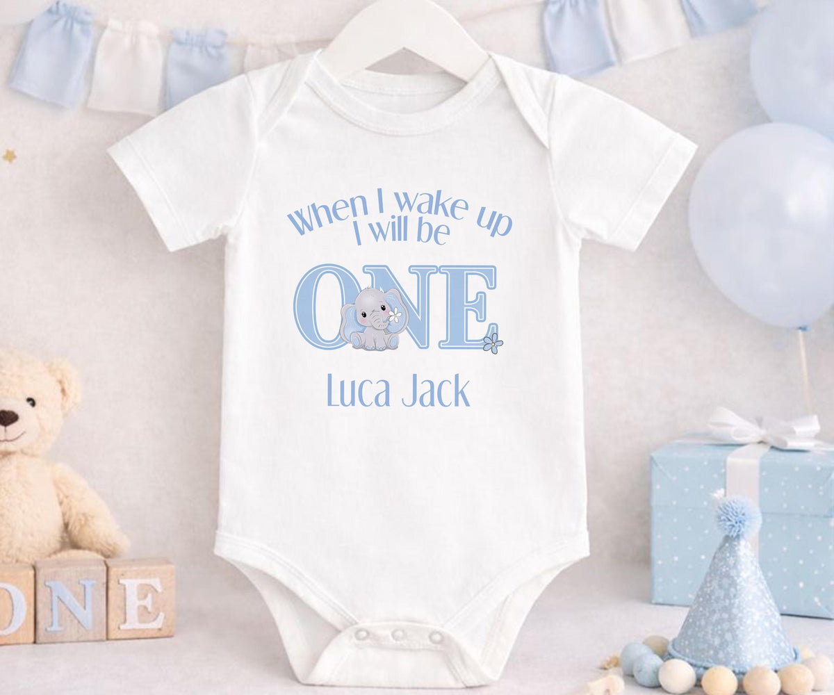 Personalised blue elephant first birthday vest with custom name printed on soft cotton.