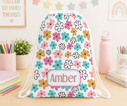 Drawstring PE bag printed with a daisy flower design, personalised with a child's name across the front
