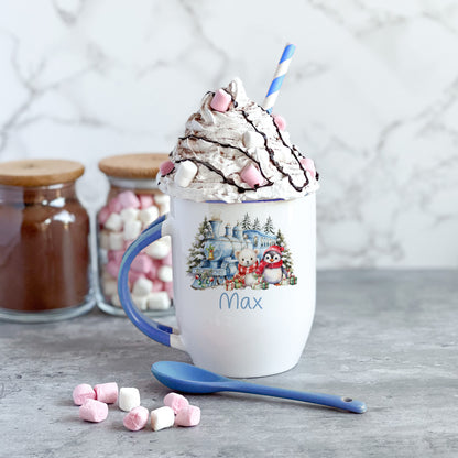 Blue handled ceramic Christmas mug with spoon, personalised with a name and penguin, polar bear and train winter design