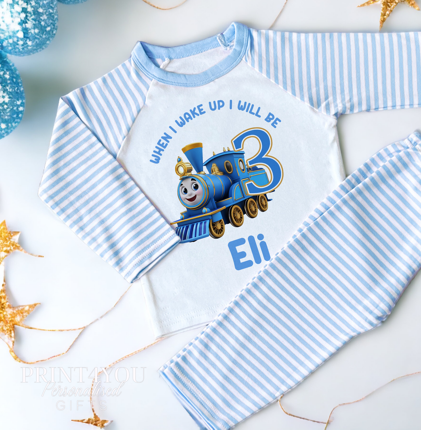 Blue and white striped personalised boys pyjamas with steam train print and custom name, size 6-12 months
