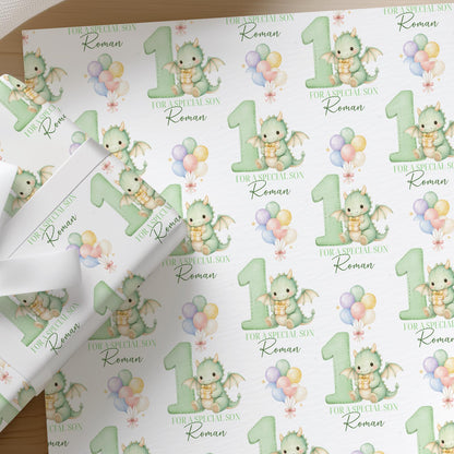Roll of personalised dragon wrapping paper with an example name printed on the design