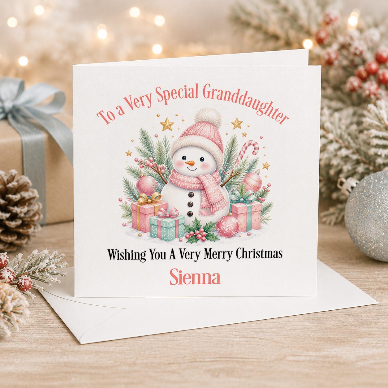 Personalised snowman Christmas card, white 6x6 inch square card printed with a pastel snowman and pink and green presents with a name