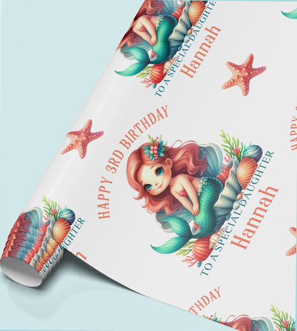 Roll of personalised mermaid birthday wrapping paper showing the repeating pastel mermaid, shell and starfish design.
