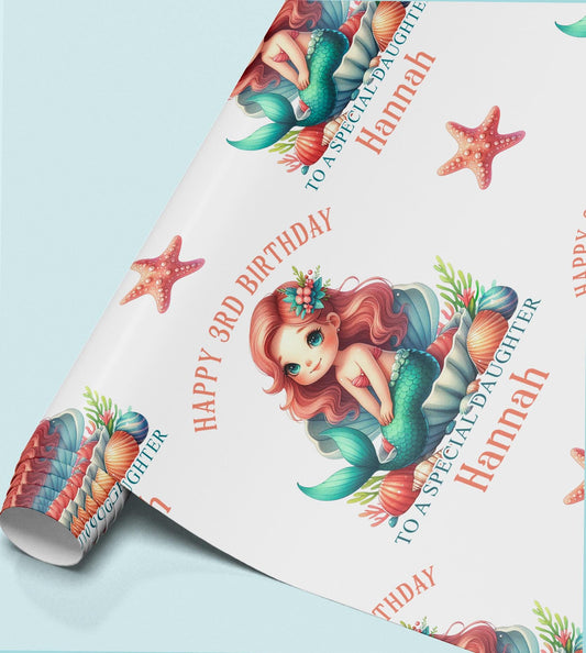 Roll of personalised mermaid birthday wrapping paper showing the repeating pastel mermaid, shell and starfish design.