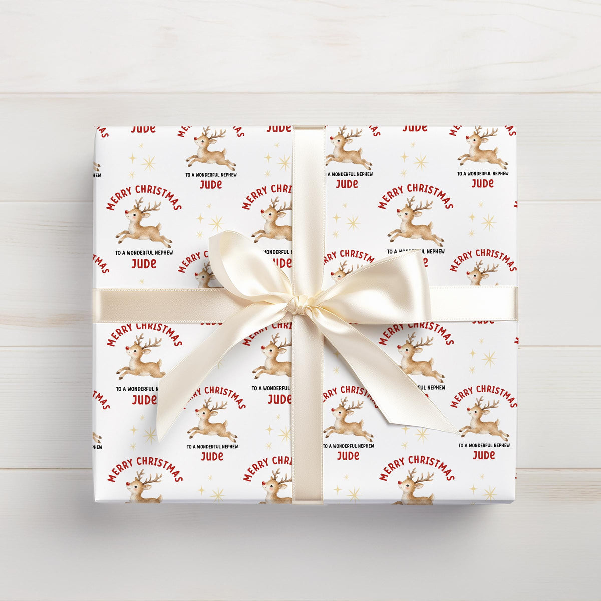 Personalised Christmas gift wrap featuring reindeer design with custom name, rolled and ready to post