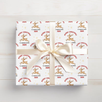 Personalised Christmas gift wrap featuring reindeer design with custom name, rolled and ready to post