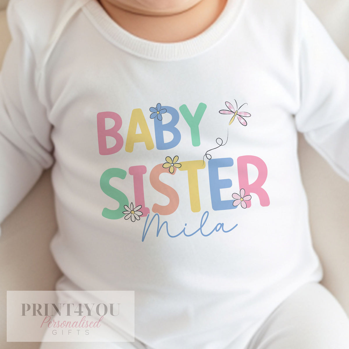 Personalised baby sister sleepsuit with popper fastenings for easy changing.