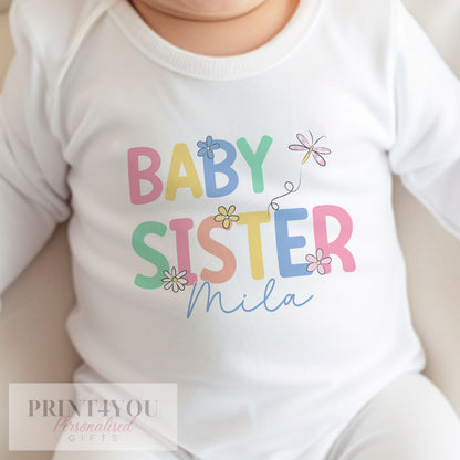 Personalised baby sister sleepsuit with popper fastenings for easy changing.