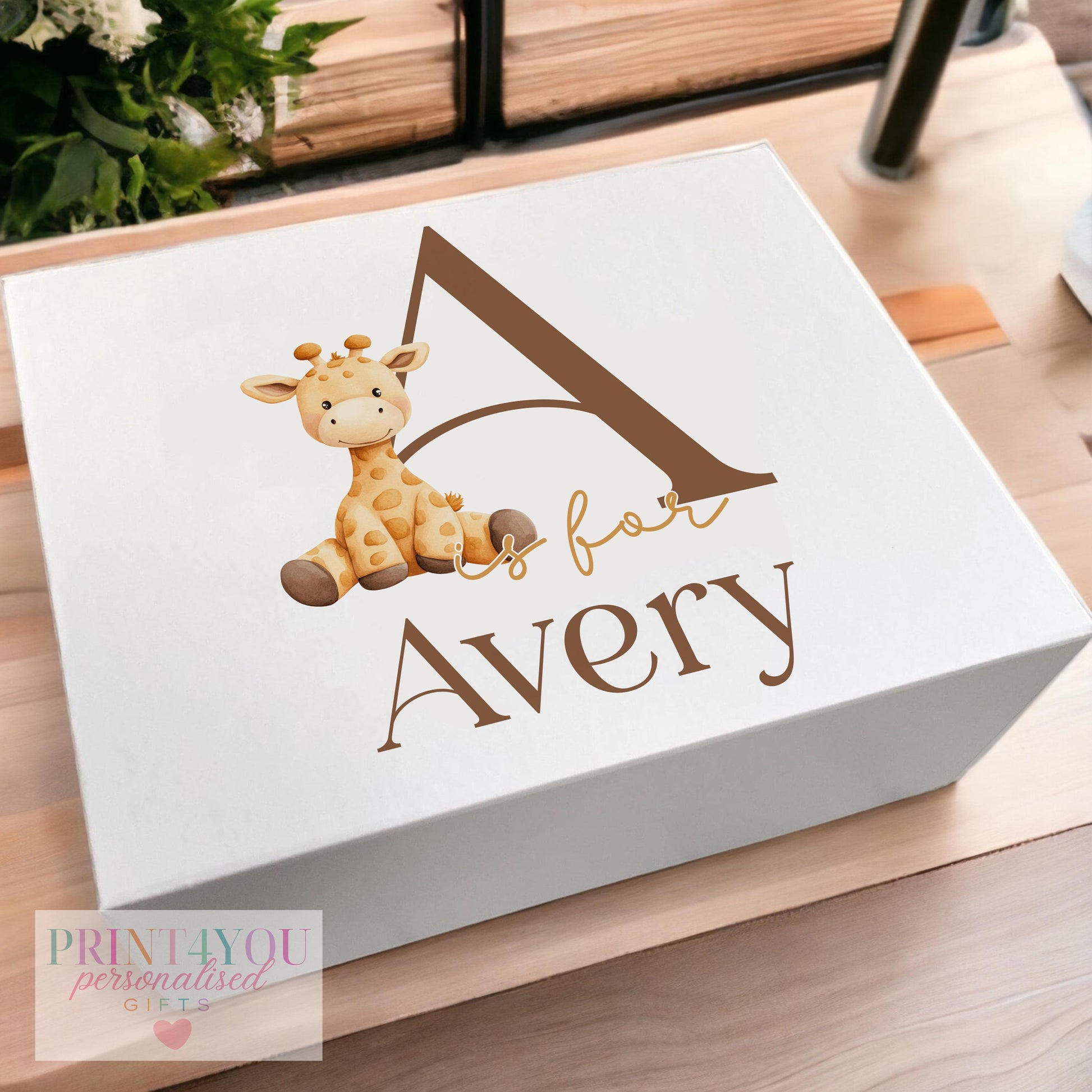 White magnetic-close keepsake box for a baby's first birthday, personalised with the child's name, an alphabet letter and a giraffe design, shown in the medium 160 x 200 x 80mm size