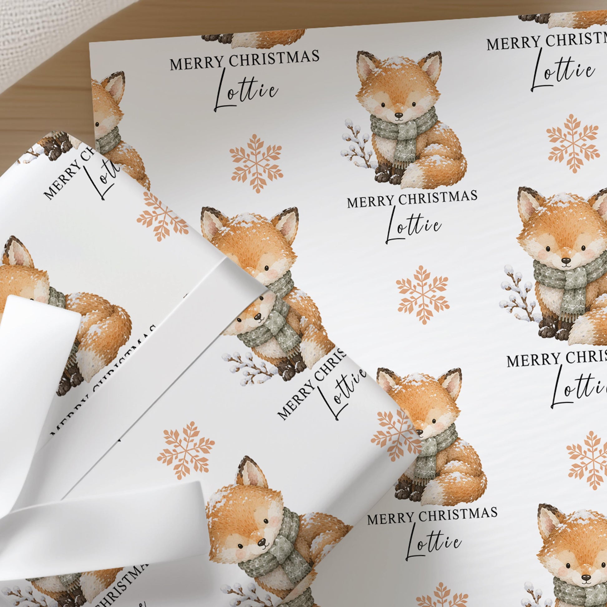 Personalised winter fox Christmas wrapping paper with custom name printed into the repeating design