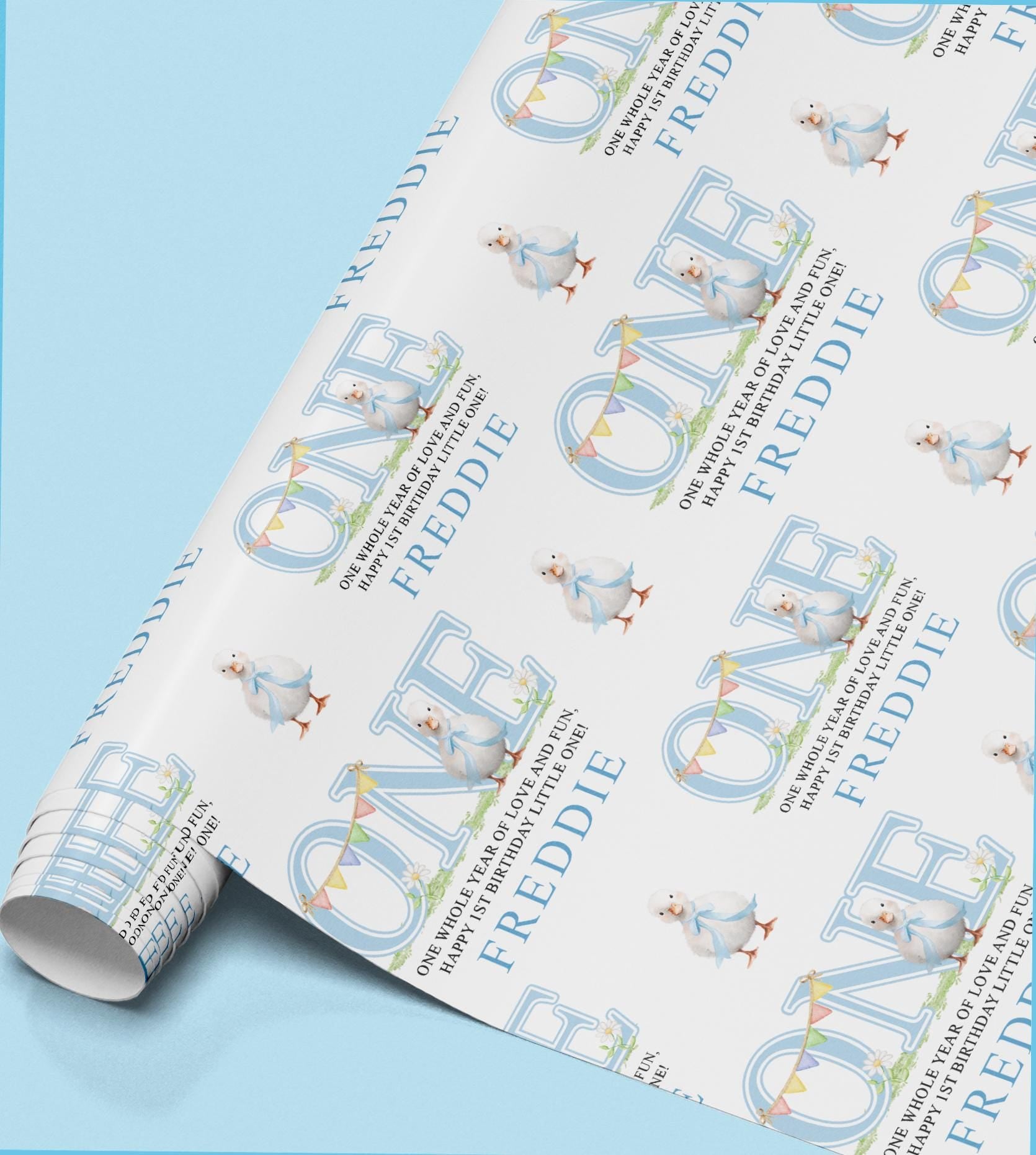Roll of personalised wrapping paper printed with the name Freddie and a small baby bird illustration.