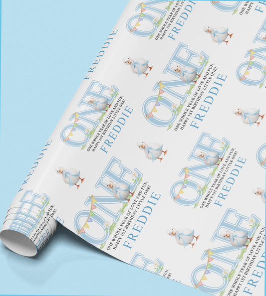 The image is a roll of wrapping paper with a repeating pattern of the name "FREDDIE" and a small illustration of a baby bird.