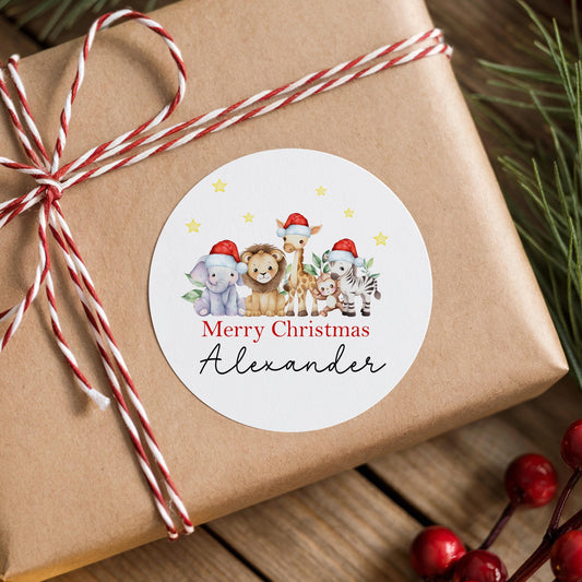 A brown gift box wrapped with a red and white striped ribbon, featuring a round sticker with a cartoon illustration of various animals wearing Santa hats.