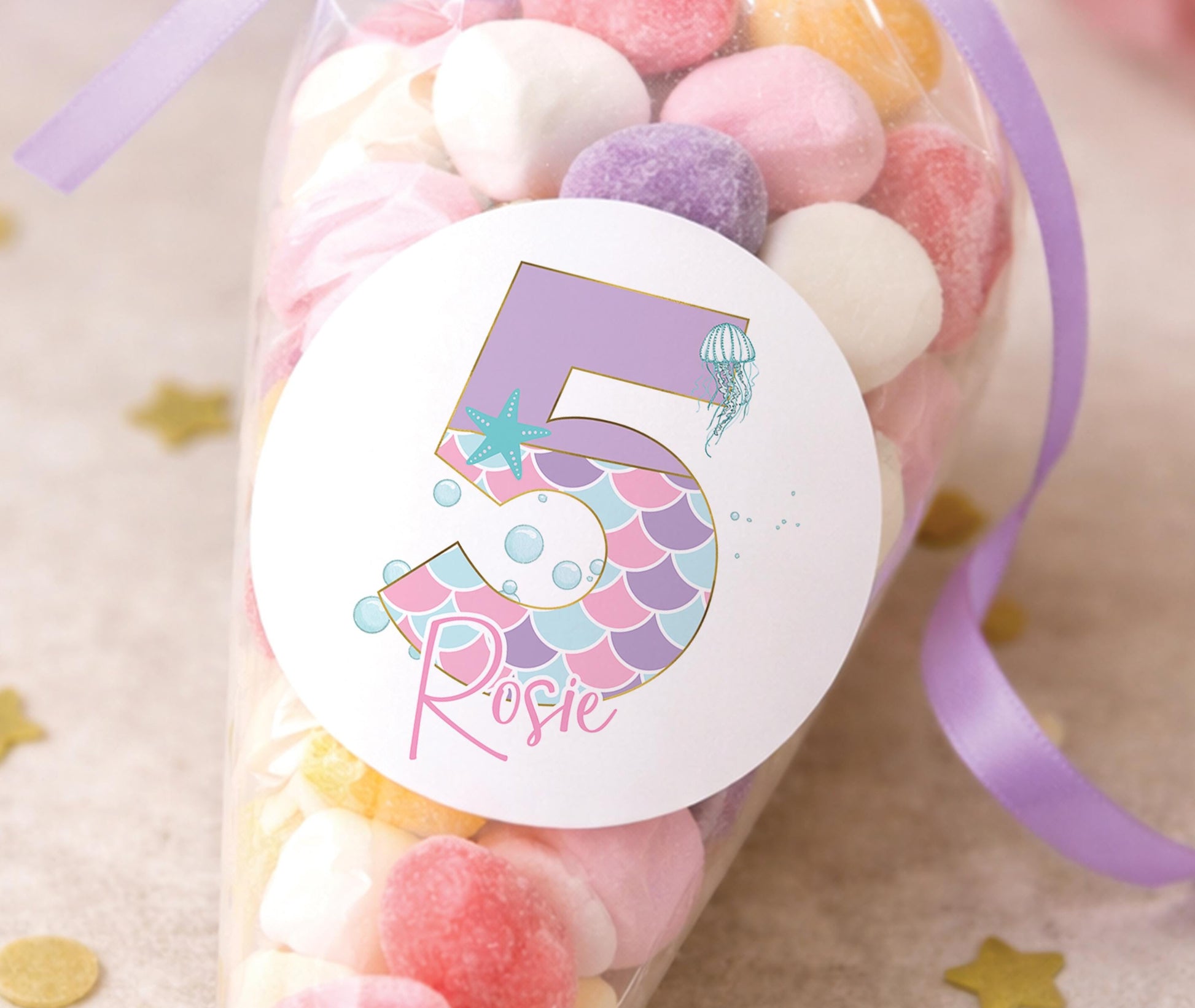 Personalised glossy mermaid birthday stickers printed with a child's name, ideal for under-the-sea party bags