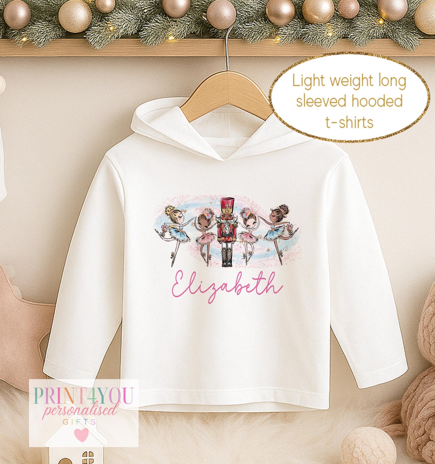 Personalised Christmas hooded t-shirt, white lightweight long sleeved hoodie printed with a nutcracker soldier and two ballerinas and a name